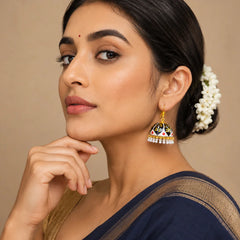 Black and gold dome jhumka earrings with intricate hand-painted motifs, subtle red accents, and pearl drop detailing, designed in a bold traditional style.