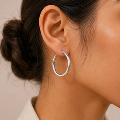 "Silver-tone hoop
earrings featuring a sleek, classic circular design with a polished finish."