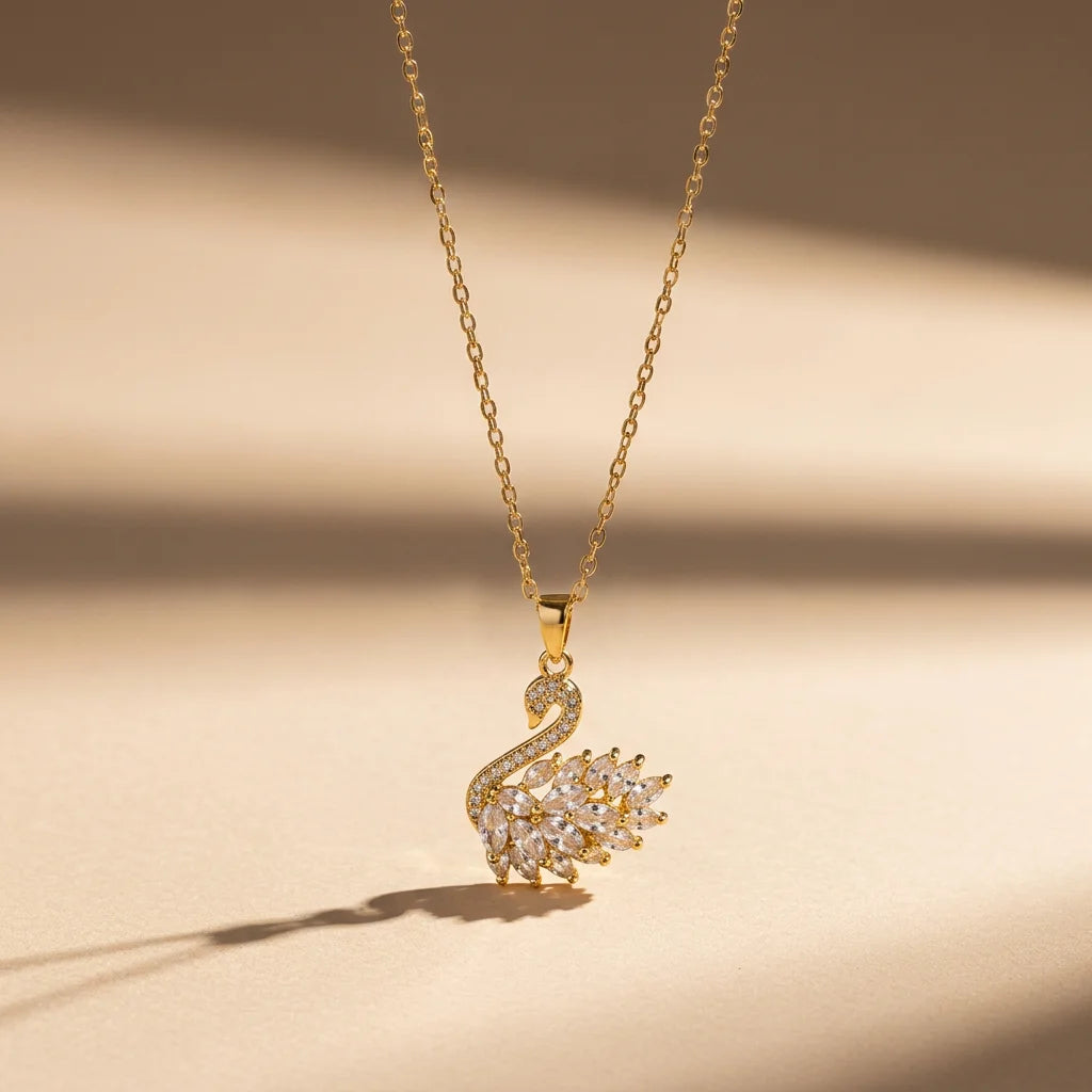 A gold swan pendant with clear cubic zirconia stones on an 18K gold plated chain. Other options include an 18K gold swan necklace with crystal detailing, a minimalist swan demi-fine necklace, and a graceful gold swan pendant for women.