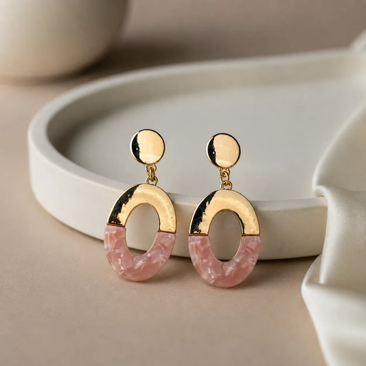 Gold-tone oval earrings with pink marble acrylic. Two-tone drop earrings with oval stud top. Minimal western statement jewelry.