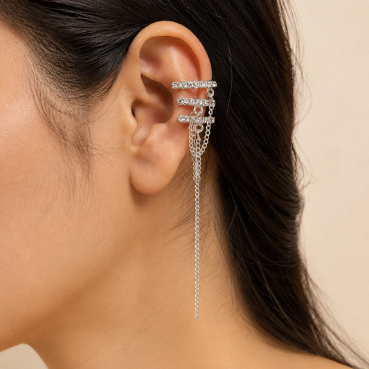 "Silver crystal ear cuff set with
sparkling rhinestones and delicate chain detailing, featuring a modern statement design for women’s contemporary fashion jewellery."