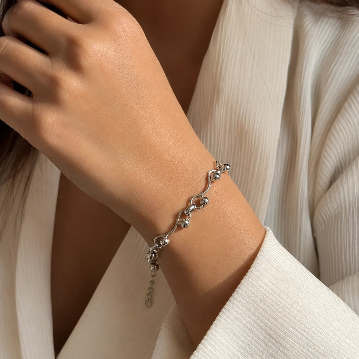 Demi-fine 925 silver plated wave link bracelet with ball details on wood. Silver tone adjustable bracelet with extension chain and lobster clasp. Modern minimalist wrist bracelet for women with high-polish finish.