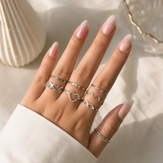 "Silver ring combo for women
featuring heart, infinity, wavy, chain-inspired and minimalist stackable ring designs."