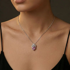 Stainless steel pendant necklace featuring a faceted pink heart crystal with clear and pink accent stones in a crown design. The hypoallergenic silver tone chain is tarnish-resistant and lightweight. Perfect coquette style necklace for parties and casual outfits.