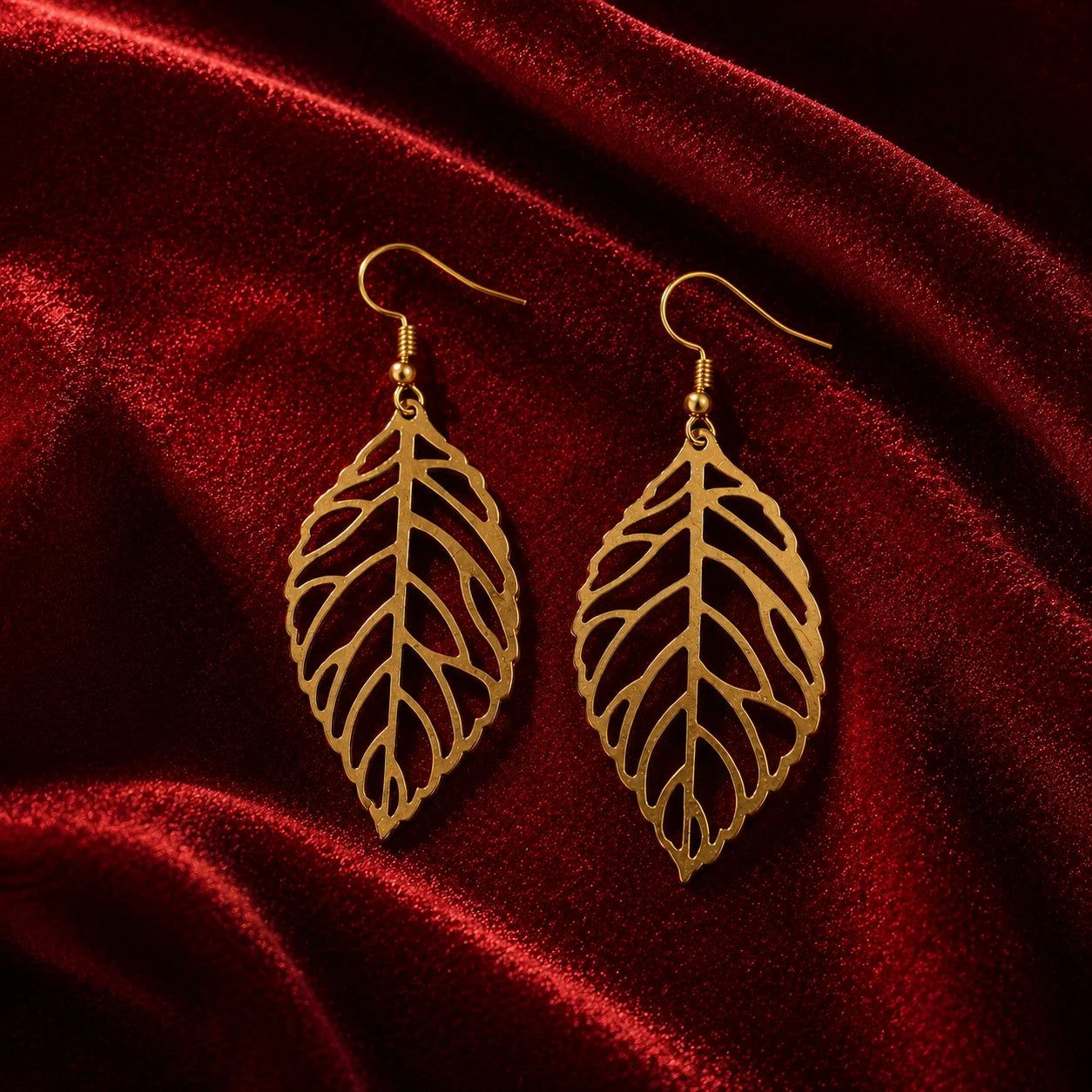 Gold leaf dangle earrings with cutwork vein design. Lightweight gold-plated fish-hook earrings with leaf silhouette. Minimal western jewelry for daily and office wear.