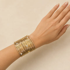 "Gold-toned handcuff
with delicate crystal-studded detailing perfect for festive occassions."