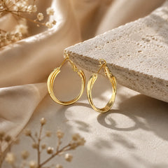 "Triple layer gold hoop earrings
featuring a sleek polished
finish and contemporary
layered band design.
Lightweight statement hoop
earrings for women, perfect
for everyday wear, office,
parties, and special occasions."