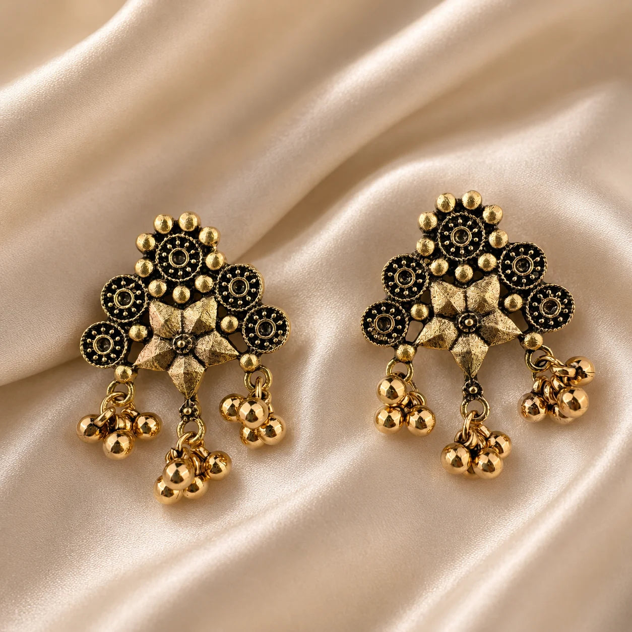 Traditional gold plated earrings with navy blue marquise stones in sunburst wreath design