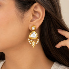 "Gold-toned statement
earrings featuring large triangular clear stones, round accents, delicate pearl bead detailing, and dangling gold charms."