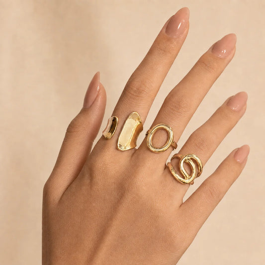"Gold statement ring combo
featuring three contemporary open rings with sculptural designs and a polished finish, perfect for stacking or wearing individually for a modern everyday look."