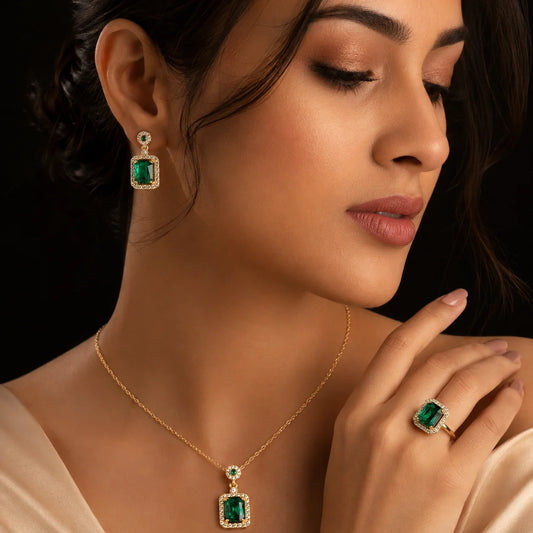 "Emerald green crystal jewellery
set featuring a gold-tone pendant necklace, matching drop earrings, and a coordinating statement ring with sparkling clear stone accents, perfect for weddings, festive occasions, parties, and elegant evening wear."