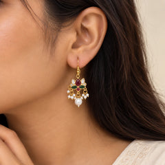 "Gold-toned floral earrings
featuring ruby-red and emerald-green enamel accents, sparkling clear stones, delicate white pearl beads, and large pearl drops."