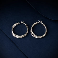 "Layered silver hoop earrings
featuring a sleek multi-band
design with a polished
silver-tone finish. Lightweight
minimalist hoop earrings for women, perfect for everyday wear, office and parties"