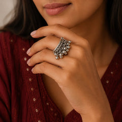 "Oxidised silver-tone
statement ring featuring layered textured bands and multiple rows of delicate dangling silver beads."