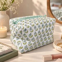 "White pouch
with a delicate green floral print and contrasting green striped trim."
