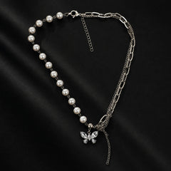 "Silver-tone statement necklace
featuring a combination of faux pearl strand, chunky chain links, layered chains, butterfly charm, and tassel detailing, designed as a trendy layered necklace for women."