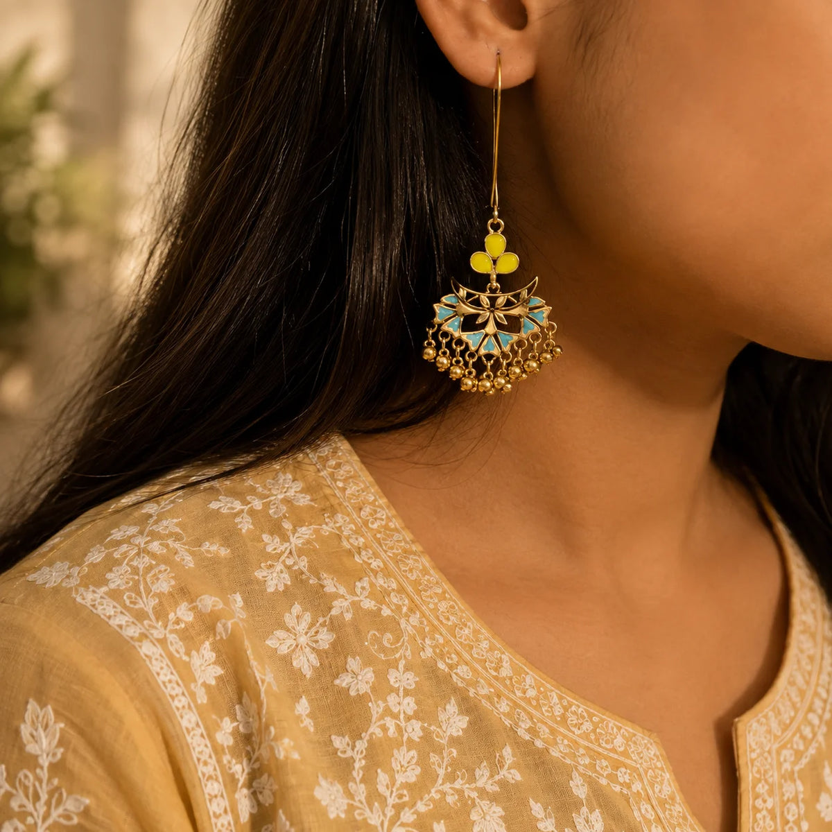 "Gold-tone enamel 
 earrings featuring intricate floral motifs, turquoise blue and lime-green accents, and delicate dangling bead details."

