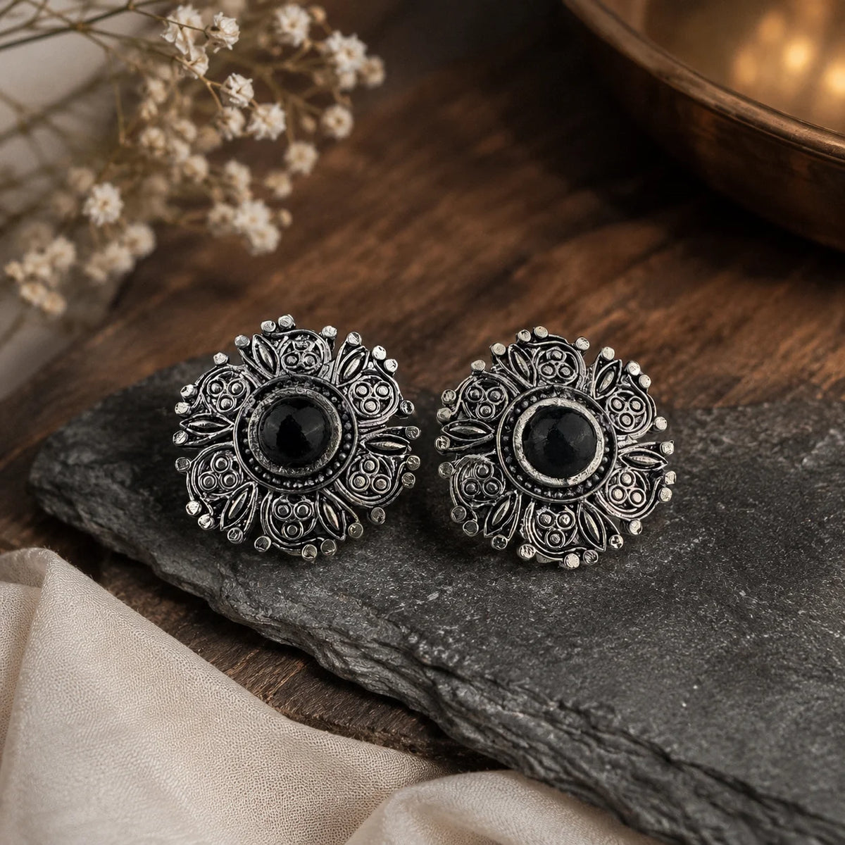 Oxidised black stone stud earrings. Intricate carved silver floral earrings with center stone and push-back closure. Boho Indian jewellery.
