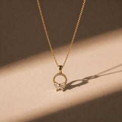 Crystal Bow Circle Pendant Necklace - 18K Gold Plated