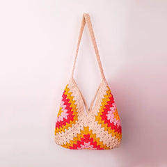 Beige crochet granny square bag with soft multicolor patchwork, handcrafted tote featuring earthy pastel tones and textured knit design.
