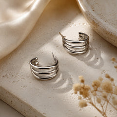 "Triple layer silver hoop earrings
 featuring a polished silver-tone 
finish and contemporary layered
 band design. Lightweight
 minimalist hoop earrings for
 women, perfect for everyday 
wear, office, parties, and special occasions."
