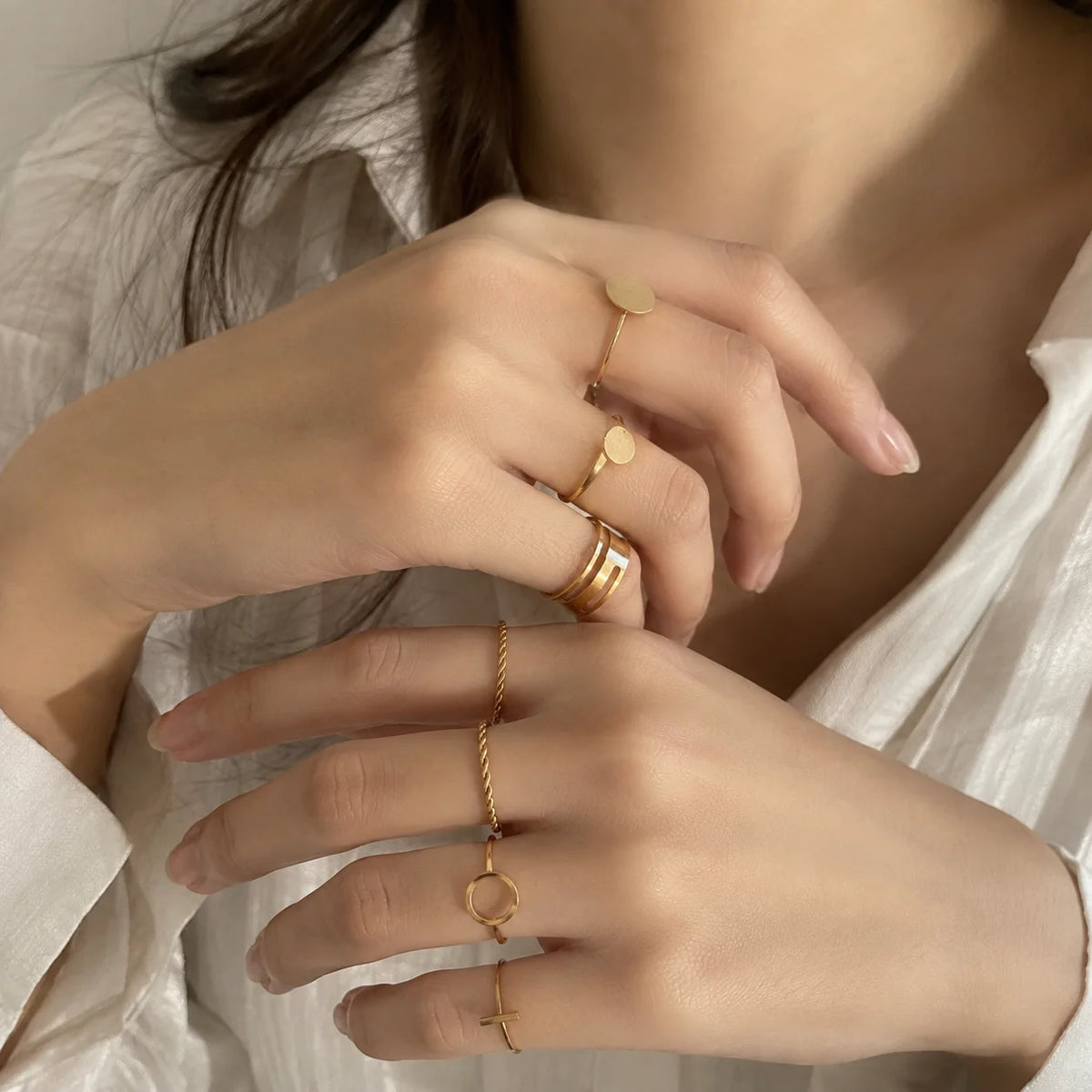 "Gold-tone ring stack
 featuring a mix of smooth, twisted, and minimalist textured bands designed for versatile layering."
