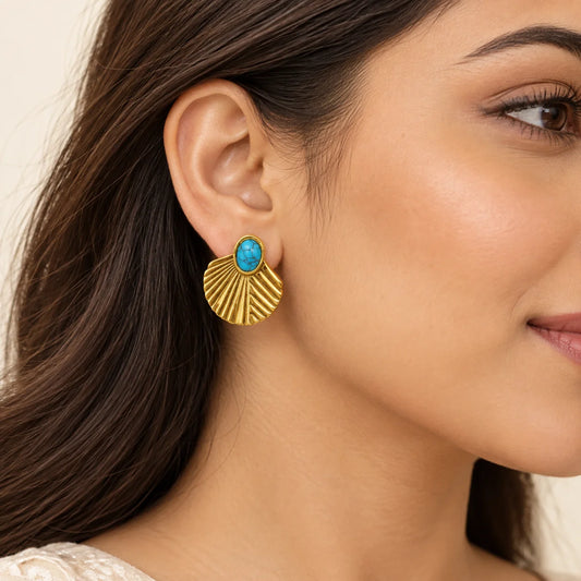"Gold-tone shell-shaped 
stud earrings featuring intricate radiating details and oval turquoise stones at the centre."
