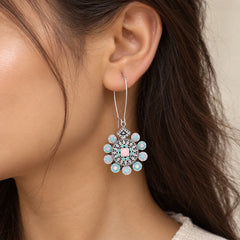 "Pair of antique gold-tone 
statement earrings with intricate circular studs, elongated traditional ornamental drops, and clusters of dangling golden bead charms."

