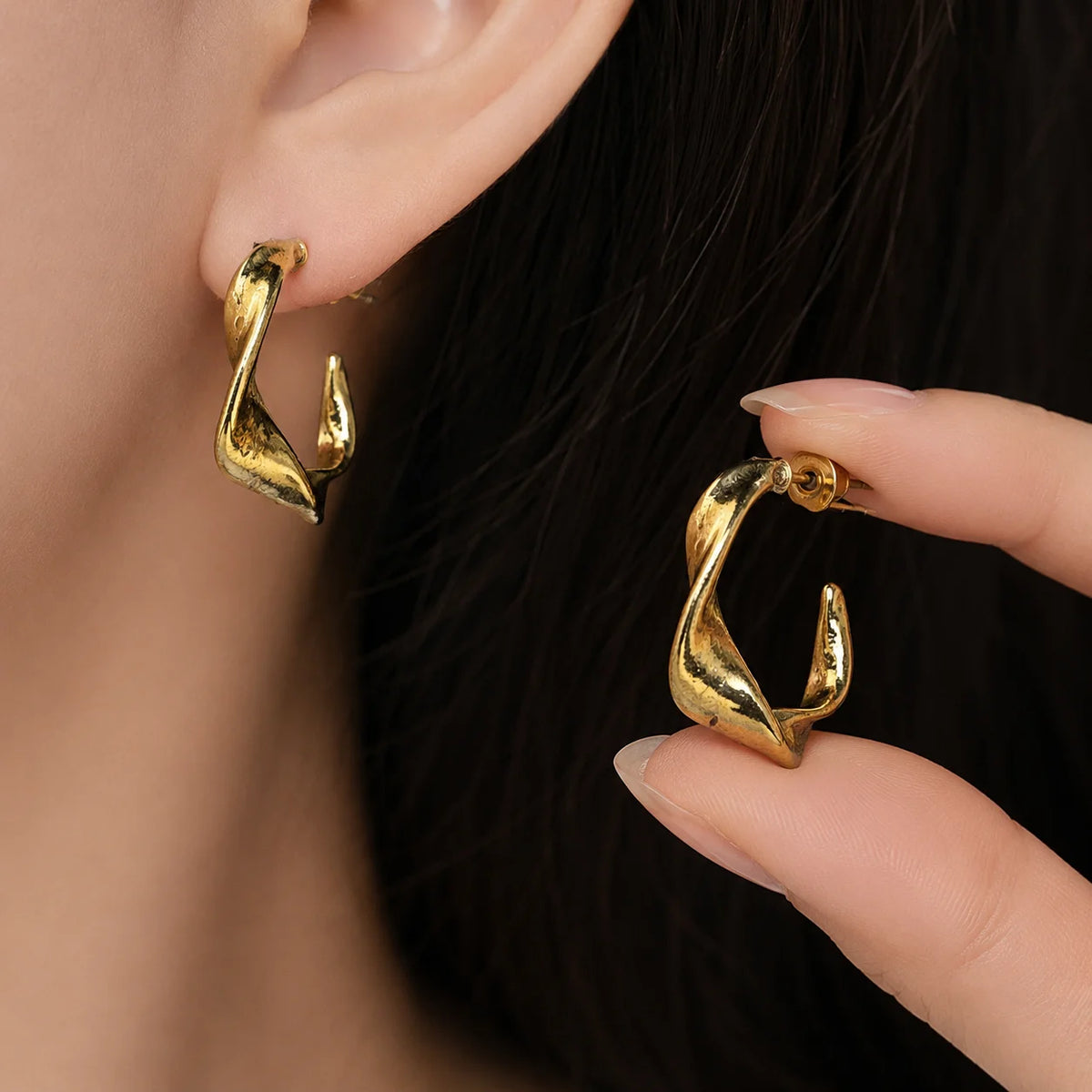 Gold twisted C hoop earrings with high-shine polished finish. Modern wave sculpted shape with post-back closure. Western demi-fine earrings for daily and office wear.