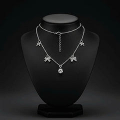 Bold silver tone necklace with large crystal bow charms and round crystal accent. Stainless steel with adjustable extender for fit. A statement demi-fine necklace for western, fusion, or party outfits.
