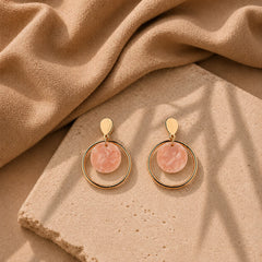 Gold circular drop earrings with pink acrylic disc. Hoop design with leaf stud top and post-back closure. Minimal western demi-fine earrings for women.
