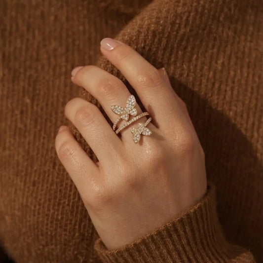 18K gold plated double butterfly wrap ring with clear cubic zirconia paved butterflies and band. The open adjustable design features two detailed butterfly motifs for a whimsical look. Perfect feminine demi-fine ring for daily or party wear.
