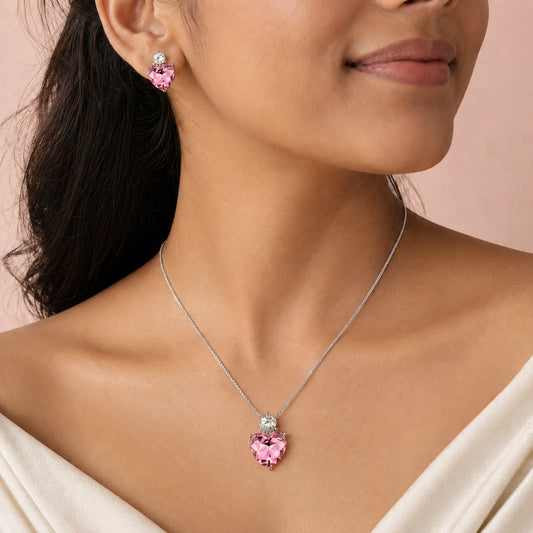 "Silver-tone heart crystal jewellery
 set featuring a pink heart pendant necklace with matching pink crystal stud earrings, perfect for everyday wear, parties, gifting, and special occasions."
