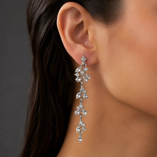 "Silver-tone crystal floral 
drop earrings featuring marquise-cut clear stones in a cascading vine design. Elegant long statement earrings for women, perfect for weddings, parties, festive occasions, evening wear, and special event styling."
.