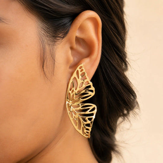 "Gold-tone butterfly statement earrings 
featuring an intricate openwork butterfly wing design with a polished finish, perfect for  parties, vacations, and contemporary fashion styling for women."
