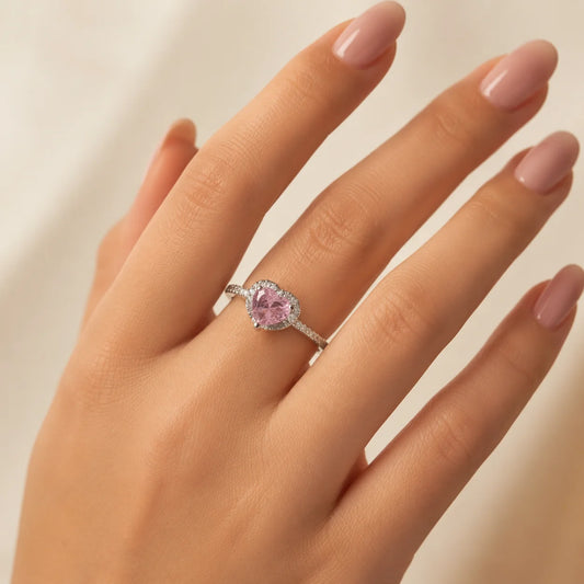 "Silver-tone heart ring
 featuring a pink heart-shaped crystal surrounded by sparkling clear stones in a halo setting. Elegant statement ring for women, perfect for everyday wear, parties, date nights, gifting, and special occasions."

