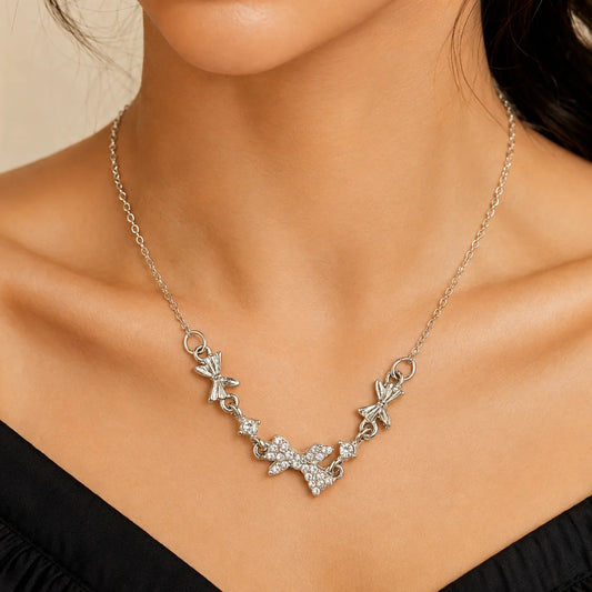 "Silver-tone butterfly charm
 necklace featuring sparkling crystal butterfly accents, delicate floral charms, and a fine chain, designed as an elegant everyday necklace for women, perfect for casual wear, parties, and special occasions."
