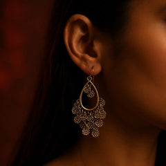 Antique gold teardrop dangle earrings with textured coin charms on wood background. Ethnic boho gold plated coin chandelier earrings with hook closure for women.
