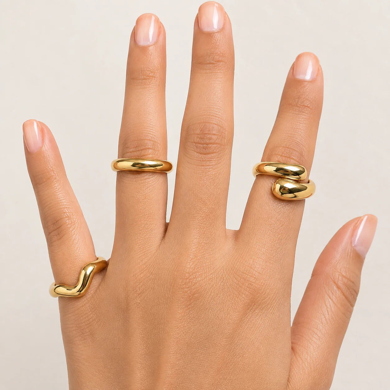 "3-piece gold statement ring 
combo featuring smooth organic wave designs with a polished gold-tone finish. A minimalist stackable ring set for women, perfect for everyday wear, modern styling, casual outfits, and special occasions."

