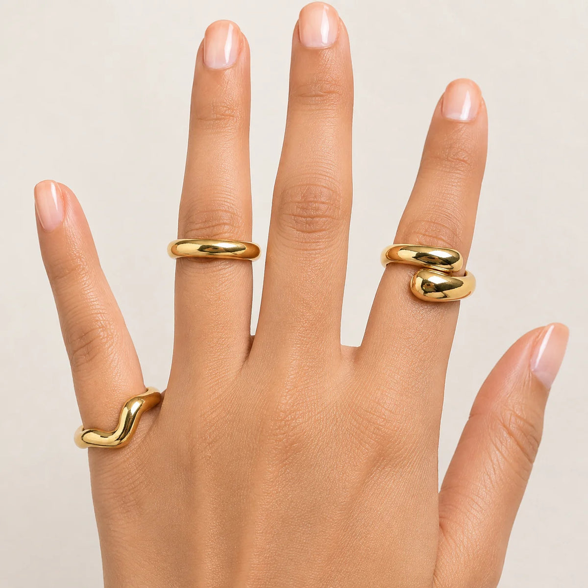 "3-piece gold statement ring 
combo featuring smooth organic wave designs with a polished gold-tone finish. A minimalist stackable ring set for women, perfect for everyday wear, modern styling, casual outfits, and special occasions."


