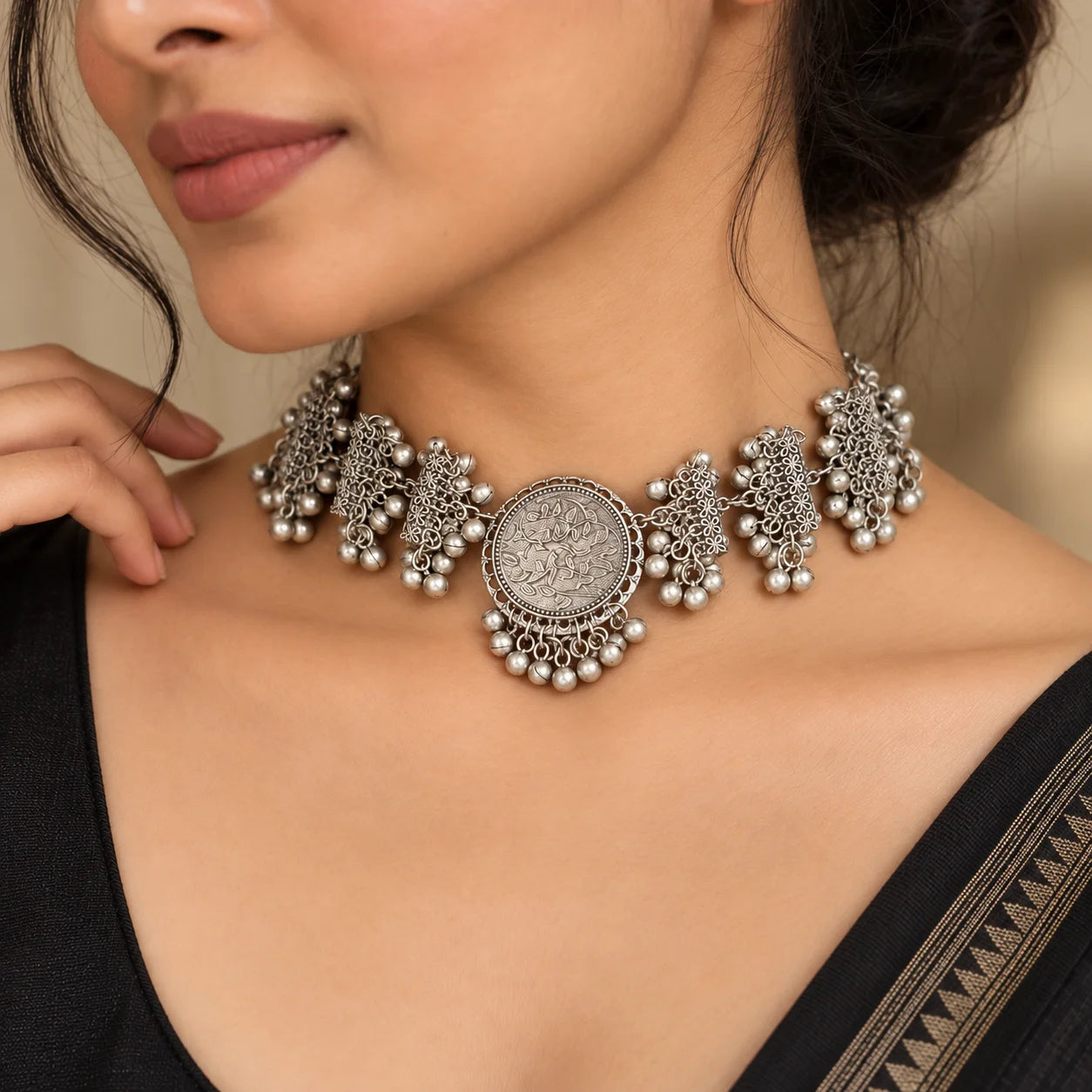 "Oxidised silver-tone
 statement choker necklace featuring intricate floral detailing, layered beadwork and a large centre piece."
