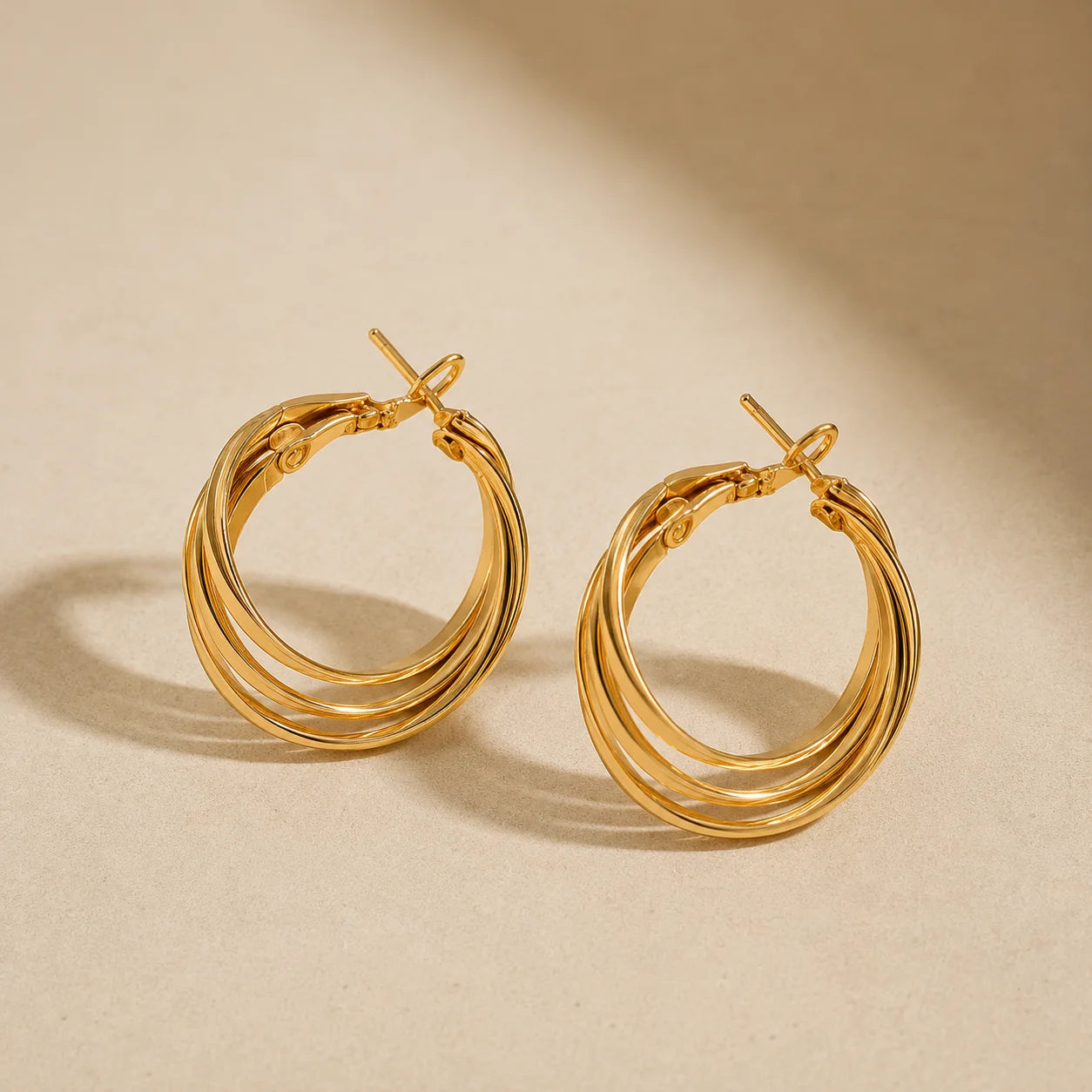 "Gold-tone layered hoop earrings 
featuring a polished multi-band design with a bold, modern silhouette, perfect for everyday wear, office styling, parties, and contemporary fashion looks for women."
