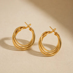 "Gold-tone layered hoop earrings 
featuring a polished multi-band design with a bold, modern silhouette, perfect for everyday wear, office styling, parties, and contemporary fashion looks for women."
