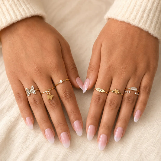 Gold plated ring combo set with 7 assorted designs including crystal butterfly and open cuff rings. Minimal stacking rings for party and office wear.
