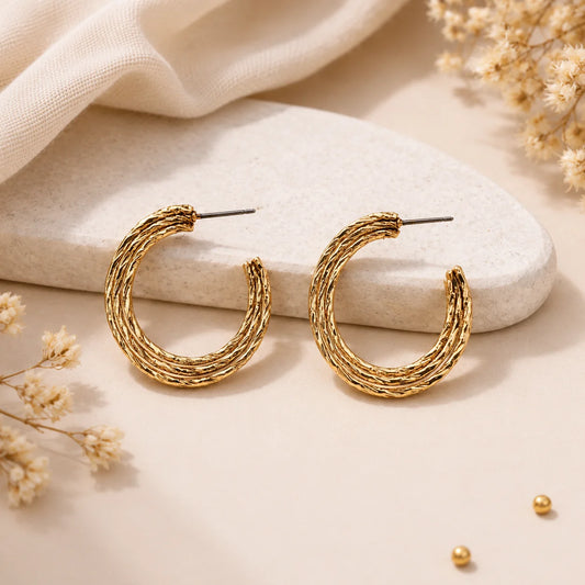 "Textured triple-layer gold hoop
 earrings featuring an organic
 hammered finish and 
polished gold-tone design.
 Lightweight statement hoop
 earrings for women, perfect
 for everyday wear parties,
 and festive occasions."
