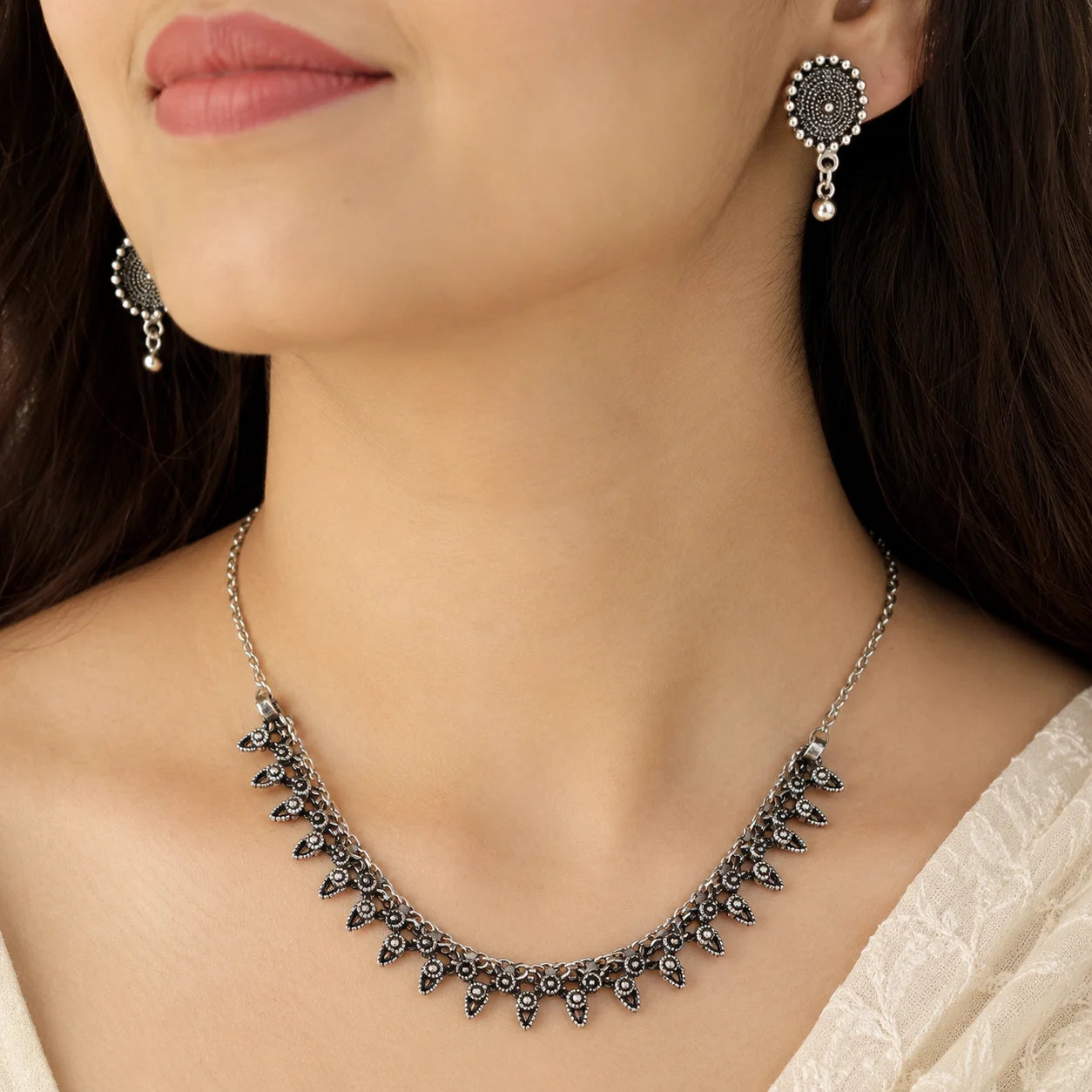Oxidised silver rava work stud earrings with bead drops from choker set
