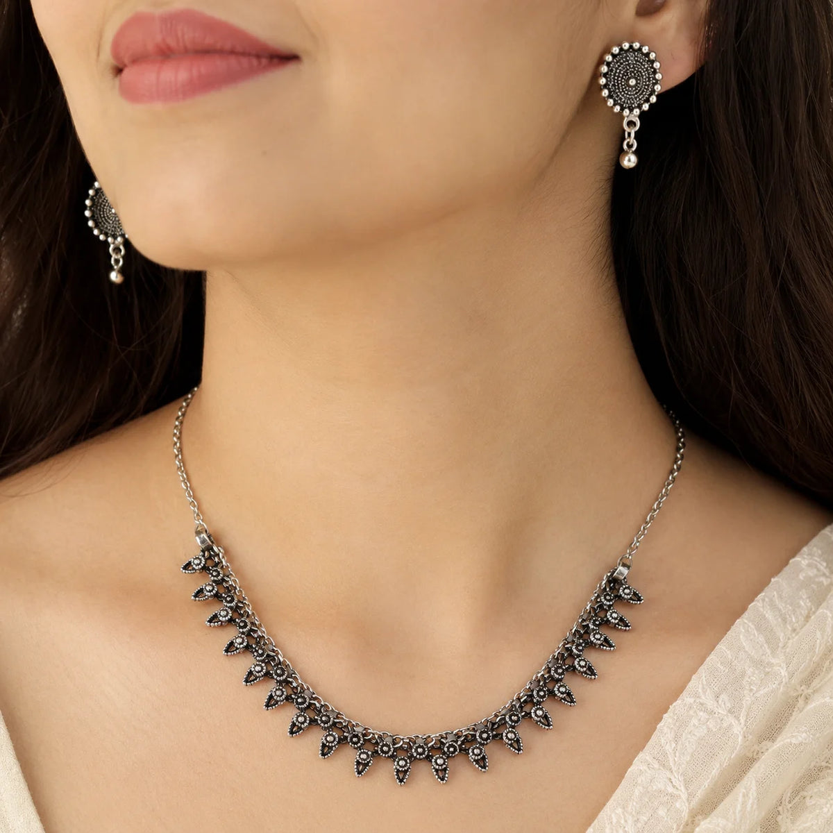 Oxidised silver rava work stud earrings with bead drops from choker set
