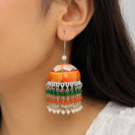 "Handcrafted floral
 Meenakari jhumka earrings featuring a painted enamel dome with green, orange, and pearl bead tassels. Traditional earrings for women, perfect for weddings and  festive celebrations"
