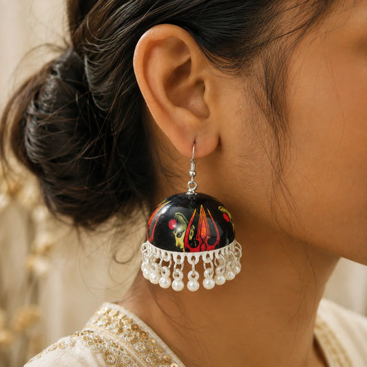 "Handcrafted black Meenakari
 jhumka earrings featuring a Maa Kali-inspired hand-painted motif with pearl bead drops. Traditional ethnic earrings for women, perfect for Navratri, Durga Puja, temple visits, festive celebrations, weddings, and Indian ethnic wear."
