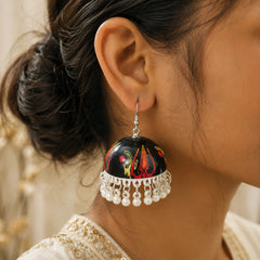 "Handcrafted black Meenakari
 jhumka earrings featuring a Maa Kali-inspired hand-painted motif with pearl bead drops. Traditional ethnic earrings for women, perfect for Navratri, Durga Puja, temple visits, festive celebrations, weddings, and Indian ethnic wear."

